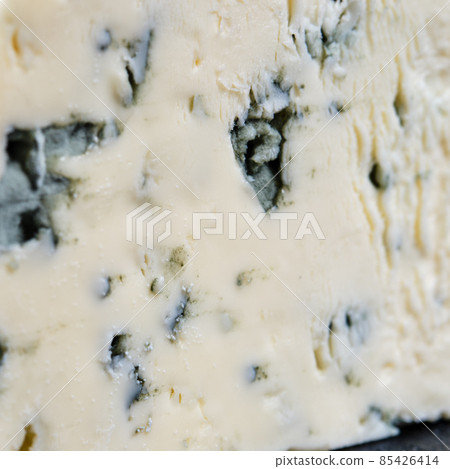 Macro photo of piece of cheese with blue mold 85426414