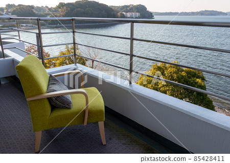 Balcony overlooking the lake and sofa for one person 85428411