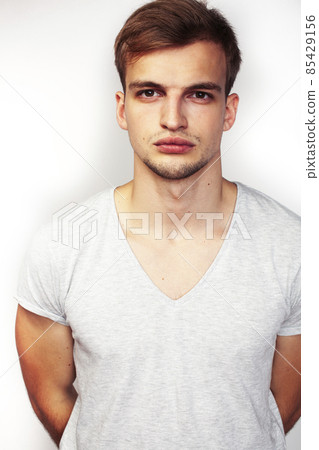 young handsome teenage hipster guy posing emotional, happy smiling against white background isolated, lifestyle people concept young handsome teenage hipster guy posing emotional, happy smiling against white background isolated, lifestyle people concept 85429156