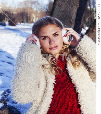 young pretty teenage hipster girl outdoor in winter snow park having coffee, lifestyle people concept 85429245