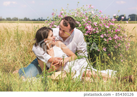 Couple near a flowering bush 85430126