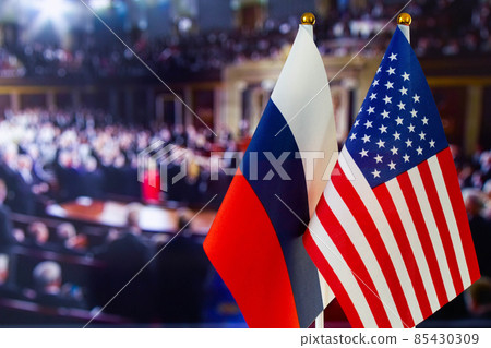 The US flag, Russian flag with copy space for text. Flag of USA, flag of Russia. The United States of America and the Russian Federation confrontation. Russia's invasion of Ukraine 85430309