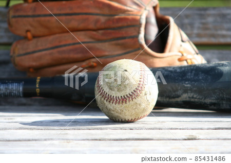Baseball ball, glove and bat on the bench 85431486