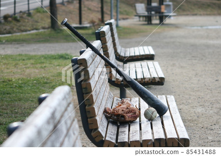Baseball ball, glove and bat on the bench 85431488