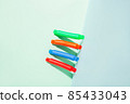 The straight folded pop tube stands leaning against the wall. Modern still life with antistress toy 85433043