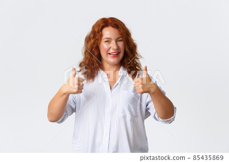 Good job, nice work gesture. Portrait of pleased smiling redhead middle-aged woman encourage you, making compliment, showing thumbs-up in approval, like product, guarantee quality 85435869