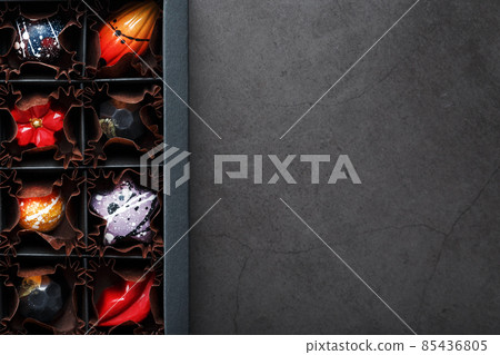 Handmade chocolates in a box on a dark background. Handmade chocolates in a box on a dark background. 85436805