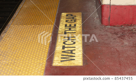 Watch the gap written on platform of train station 85437455