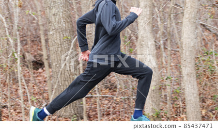 Fast runner running in the woods with a blurred background 85437471