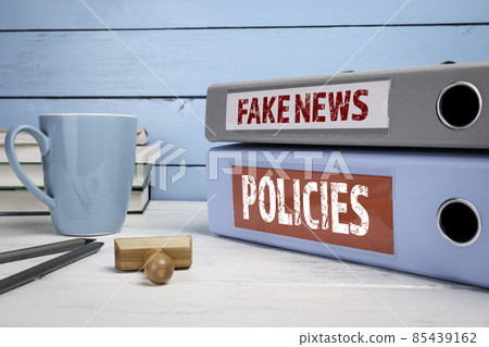 Fake News and Policies concept. Office supplies on a white table Fake News and Policies concept. Office supplies on a white table 85439162