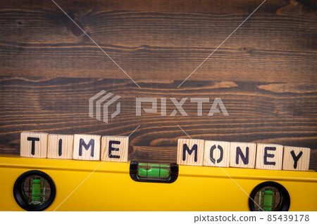 Time and Money balance concept. Spirit level on a wooden background 85439178