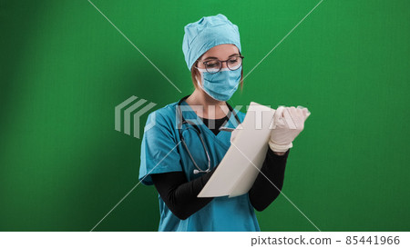 Female doctor takes notes in a file Female doctor takes notes in a file 85441966
