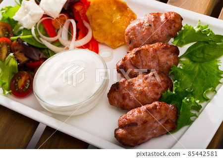 Minced meat kebapcheta served with salad of greens and brynza 85442581