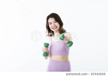 Female dumbbell punch training smile looking at the camera Female dumbbell punch training smile looking at the camera 85442608