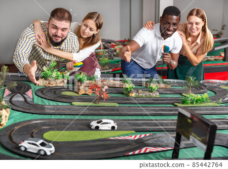 Girls with guys play slot car racing models 85442764
