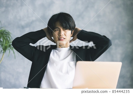 Man holding his head Man holding his head 85444235