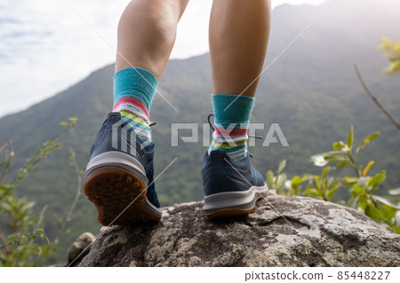 Successful hike stand on mountain top cliff edge Successful hike stand on mountain top cliff edge 85448227