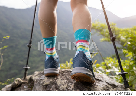 Successful hike stand on mountain top cliff edge Successful hike stand on mountain top cliff edge 85448228