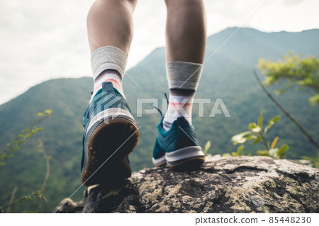 Successful hike stand on mountain top cliff edge Successful hike stand on mountain top cliff edge 85448230