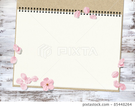 White-painted wooden deck and sketchbook with a background of cherry blossoms 85448264