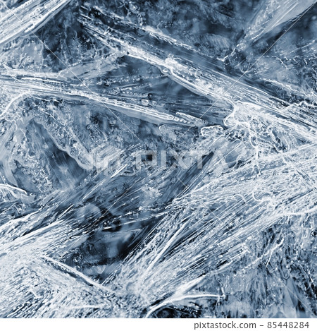 Frozen pool of water in winter. Ice nature - macro shot of frozen water. 85448284