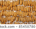 Dried corn clams on the wall background. raw yellow organic corn closeup. Plant farmer. rural, rustic concept. Selective focus. Top view. Flat lay. Pattern. Corn background. The corn harvest. Eco-corn 85450780
