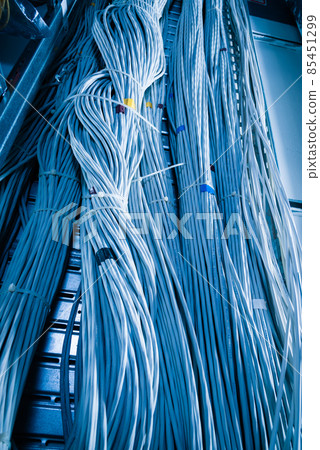 bunch of network cables in wave pattern leading across server ro bunch of network cables in wave pattern leading across server ro 85451299