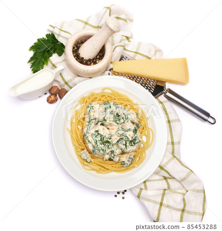 Portion of delicious meatballs with spinach in a creamy sauce and pasta 85453288