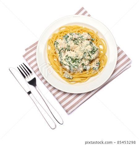 Portion of delicious meatballs with spinach in a creamy sauce and pasta 85453298