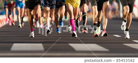 Marathon running race, people feet on city road, runners run urban marathon in the the city Marathon running race, people feet on city road, runners run urban marathon in the the city 85453582
