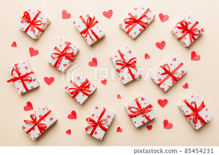 Valentine day composition Background: red gift box with bow and heart. Christmas present. View from above. Holday greeting card Valentine day composition Background: red gift box with bow and heart. Christmas present. View from above. Holday greeting card 85454231