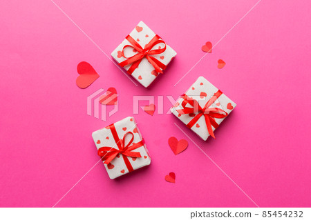 Valentine day composition Background: red gift box with bow and heart. Christmas present. View from above. Holday greeting card Valentine day composition Background: red gift box with bow and heart. Christmas present. View from above. Holday greeting card 85454232