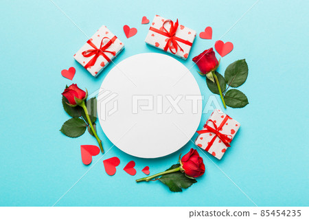 Frame made of rose, git box, heart and blank greeting card mockup on Colored background. Top view, flat lay, copy space Holiday, Mothers Day, birthday concept Frame made of rose, git box, heart and blank greeting card mockup on Colored background. Top view, flat lay, copy space Holiday, Mothers Day, birthday concept 85454235