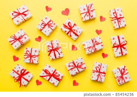 Valentine day composition Background: red gift box with bow and heart. Christmas present. View from above. Holday greeting card Valentine day composition Background: red gift box with bow and heart. Christmas present. View from above. Holday greeting card 85454236