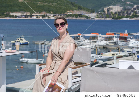 Young woman in a terrace of a summer cafe 85460595