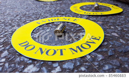 Bullet shell in middle of a yellow circle with text "evidence do not move" the circle on black background, concept for crime scene investigation Bullet shell in middle of a yellow circle with text "evidence do not move" the circle on black background, concept for crime scene investigation 85460883