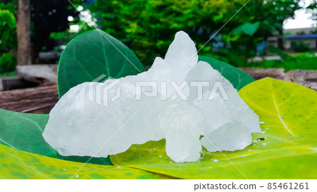 Alum cubes on green leaf. Alum is widely used in deodorant industry. 85461261
