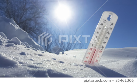 The thermometer in winter lies on the snow and shows low negative air temperature. Meteorological conditions in the harsh climate in the northern regions and the environment.Climate change on Earth The thermometer in winter lies on the snow and shows low negative air temperature. Meteorological conditions in the harsh climate in the northern regions and the environment.Climate change on Earth 85461306