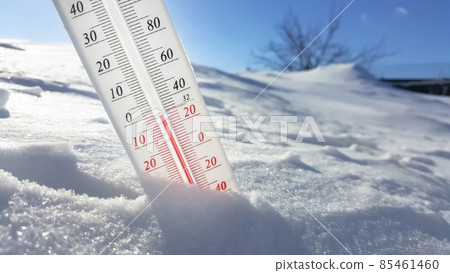 The thermometer in winter lies on the snow and shows low negative air temperature. Meteorological conditions in the harsh climate in the northern regions and the environment.Climate change on Earth 85461460