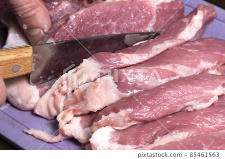 Slice the pork or beef with a knife on the table in close-up.Preparation of meat dishes and food products.Pieces of red meat for shish kebab,barbecue or kebab.Raw fresh meat is cut with a knife.recipe Slice the pork or beef with a knife on the table in close-up.Preparation of meat dishes and food products.Pieces of red meat for shish kebab,barbecue or kebab.Raw fresh meat is cut with a knife.recipe 85461563