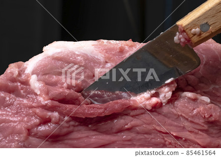 Slice the pork or beef with a knife on the table in close-up.Preparation of meat dishes and food products.Pieces of red meat for shish kebab,barbecue or kebab.Raw fresh meat is cut with a knife.recipe Slice the pork or beef with a knife on the table in close-up.Preparation of meat dishes and food products.Pieces of red meat for shish kebab,barbecue or kebab.Raw fresh meat is cut with a knife.recipe 85461564