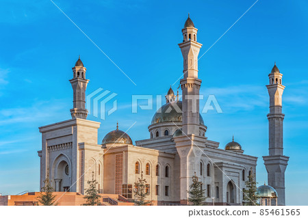 A Muslim Islamic mosque with golden minarets and a crescent moon against the sky.A religious temple for praying and worshipping the God of Muslims in Islamic culture and belief in Allah. 85461565