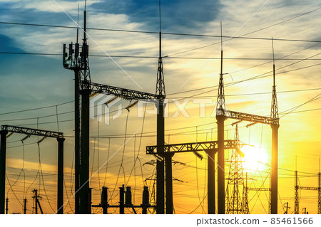 Production of fuel and electricity.Electrical networks with wires and transformers at sunset.Power transmission lines and from the power plant.Power lines with wires under voltage and electric current Production of fuel and electricity.Electrical networks with wires and transformers at sunset.Power transmission lines and from the power plant.Power lines with wires under voltage and electric current 85461566