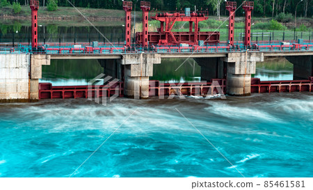 River, dam, bridge. Car and pedestrian bridge in the morning. A full-flowing river with a strong current. Clean, bubbling, fresh water.Technical construction on the river, fresh water reserves River, dam, bridge. Car and pedestrian bridge in the morning. A full-flowing river with a strong current. Clean, bubbling, fresh water.Technical construction on the river, fresh water reserves 85461581