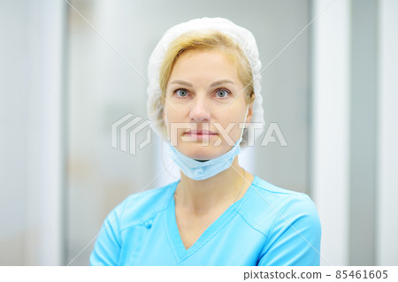 Portrait of the female surgeon is conducting the reception of patients. Doctor is preparing for surgery in operation room. Portrait of the female surgeon is conducting the reception of patients. Doctor is preparing for surgery in operation room. 85461605