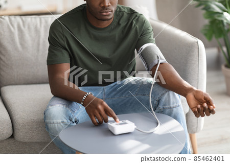 Cropped of black man checking blood pressure at home 85462401