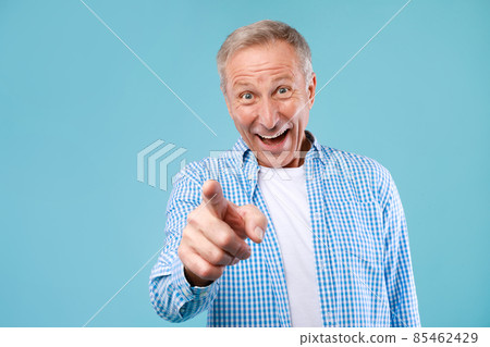 Happy mature man pointing fingers at camera at studio Happy mature man pointing fingers at camera at studio 85462429