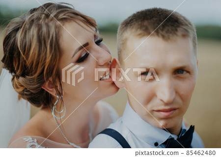 Hot woman showing tenderness man in garden. Portrait of sexy couple expressing feelings in park. Close up gorgeous bride and groom kissing on wedding ceremony outdoors. Bride and groom kisses tenderly Hot woman showing tenderness man in garden. Portrait of sexy couple expressing feelings in park. Close up gorgeous bride and groom kissing on wedding ceremony outdoors. Bride and groom kisses tenderly 85462480