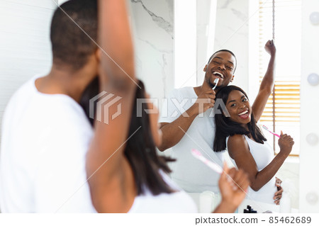 Joyful Black Couple Singing And Dancing While Brushing Teeth In Bathroom Joyful Black Couple Singing And Dancing While Brushing Teeth In Bathroom 85462689