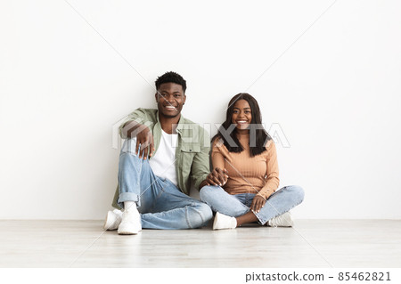 Happy black lady bonding with her happy boyfriend, white background Happy black lady bonding with her happy boyfriend, white background 85462821